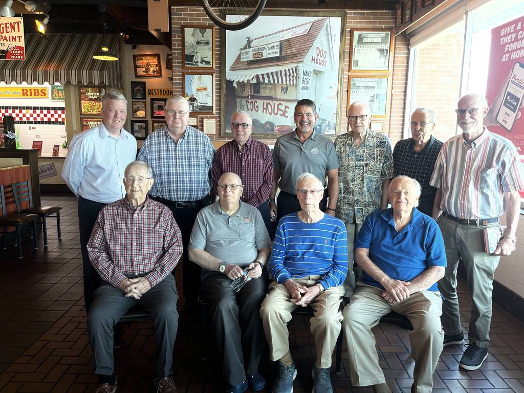 Members of the Orland Park-based Smith's Crossing Men's Book Club pose with Michael Portillo, manager of Portillo's restaurant chain, after discussing the company's history that began in the Chicago suburbs.  Portillo, 
