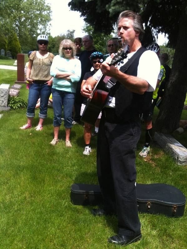 Harmonica Neil performs at Big Bill Broonzy's grave at Lincoln Cemetery on Blue Island during the previous Graveyard Blues Tour hosted by Friends of the Cal-Sag Trail.