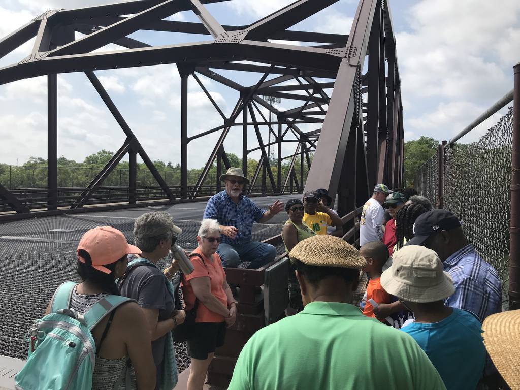 Historian Larry McClellan, center, describes to a tour group in 2019 how the Indiana Avenue bridge over the Little Calumet River on Chicago's Riverdale border became a transit area as freedom seekers flee to Canada via the Underground Railroad.