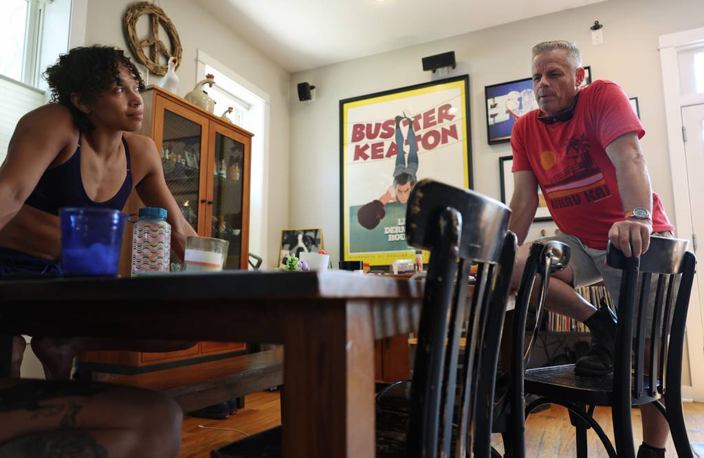 Isabella “Bella” Diaz listens to Midnight Circus founder Jeff Jenkins talk about this season's schedule, which runs through a weekend in September, at her Chicago home on August 24, 2023. 