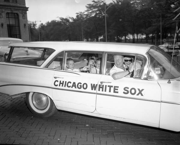 Bill Veeck and his family leave the Shoreland Hotel in Chicago for Maryland on July 22, 1961.  Children: Mike, 10, Marya, 6, Greg, 5, and Lisa, 2 1/2.  His wife, Mary Francis (in the front seat), holds her daughter, Juliana. 