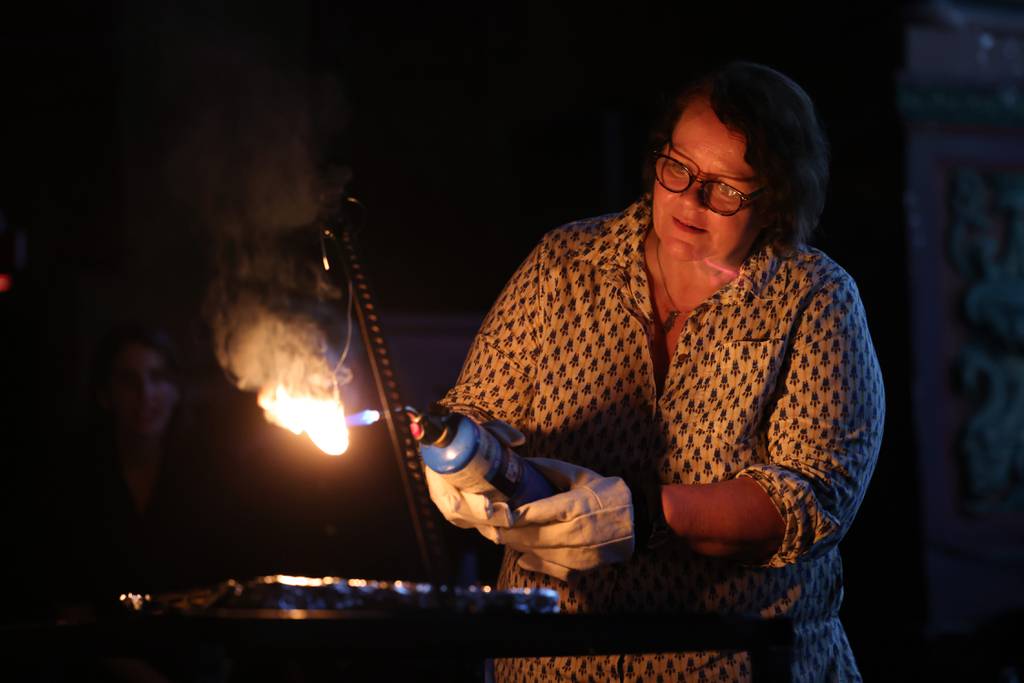 After the screening of her short film in front of an audience, filmmaker Ines Sommer uses a blowtorch to burn the memory stick containing her short film. "Destroy Your Art" event on September 26, 2023 at the Music Box Theater in Chicago. 