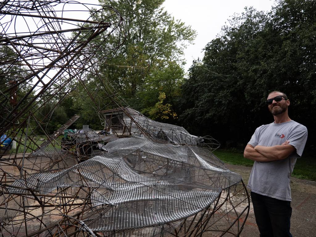 Naperville artist Lucas Salvesen stands next to the frame of the 50-foot werewolf art installation he and longtime friend Paul Kuhn created for Naper Settlement's annual fall events All Hallows Eve and Howlin' at the Moon. 
