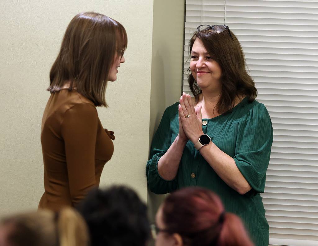 Trisha Johnson, mother of Hampshire High School senior Julia Johnson, applauds her daughter after speaking out in favor of the school's video production "prom" at the District 300 school board meeting Oct. 24 in Algonquin. "He did well" said the proud mother. 
