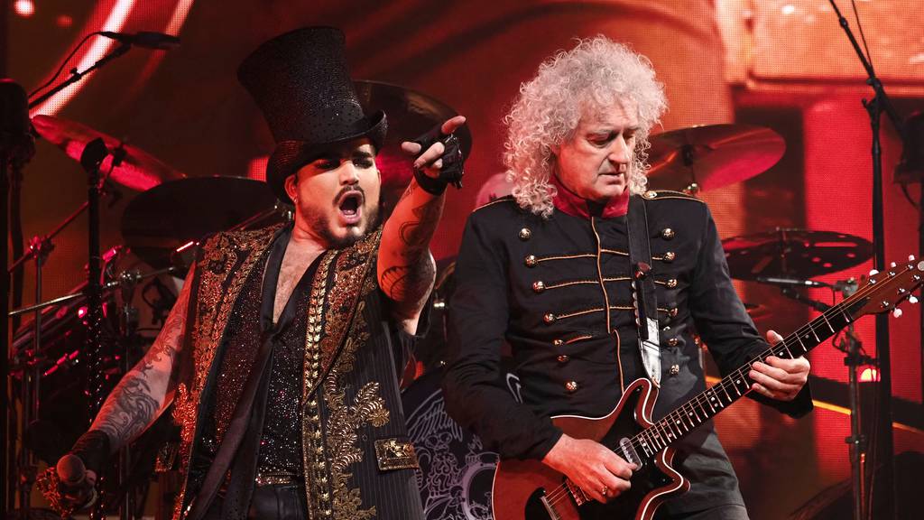 Vocalist Adam Lambert (left) and guitarist Brian May perform during Queen and Adam Lambert's European tour concert in Bologna, Italy, in July 2022.