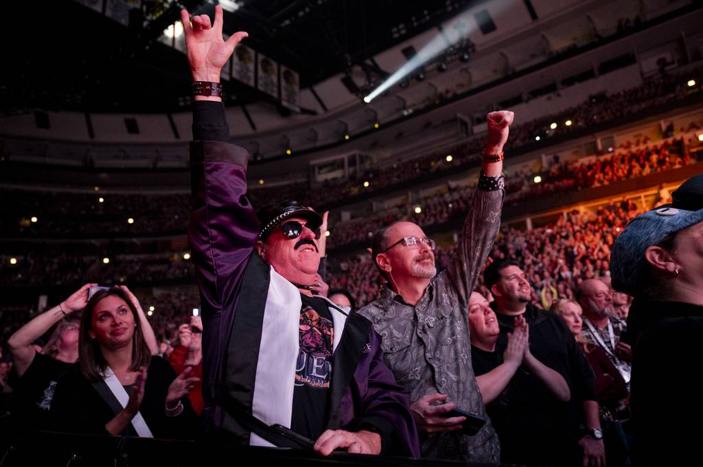 Darren Smith (left), dressed as Freddie Mercury, cheers during the first night of Queen and Adam Lambert's two performances at the United Center on October 30, 2023. 