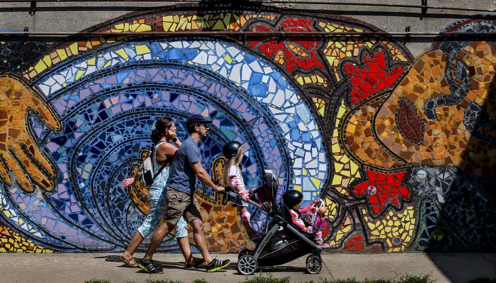 pedestrians crossing "Indian Black Dance" Mosaic near Foster Beach in Chicago on August 3, 2021. 