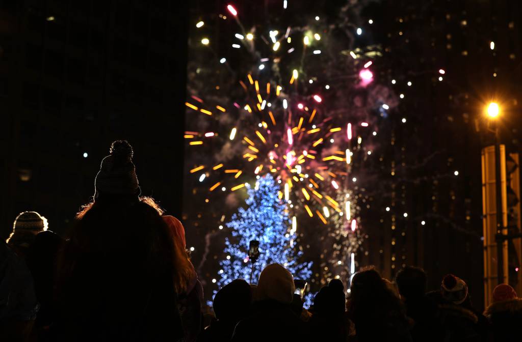 People watch the fireworks display at the Magnificent Mile Lights Festival on Michigan Avenue in Chicago on November 18, 2017.