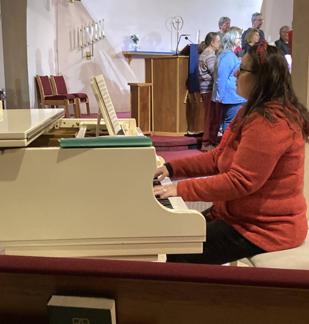 Musichorale director Sarah Silhan-Koehler accompanies the band during a recent rehearsal at Our Savior Lutheran Church in Burbank.  He took on the role of director in 2017, but he has been a singer and accompanist in the band since his childhood.