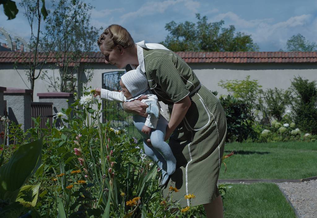 Hedwig Hoss, wife of Auschwitz commandant Rudolph Hoss, tends to her newborn baby and the family garden. "Area of ​​Interest."