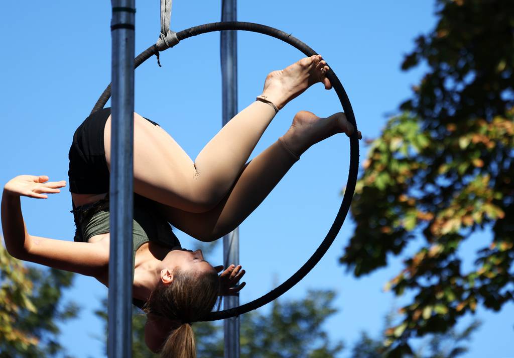 Midnight Circus member Samantha Rae Jenkins performs on a strap-on ring at Humboldt Park in Chicago on October 1, 2022.  Midnight Circus is a 2024 NEA grant recipient. 