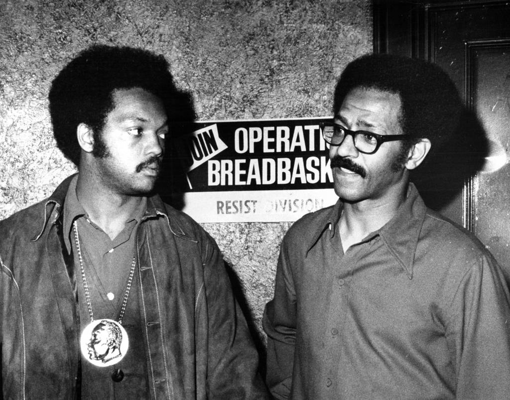 The Rev. Jesse Jackson (left), leader of Operation Breadbasket, joins Breadbasket program director St. Louis on June 9, 1971, at 7941 S. Halsted St. in Chicago.  Clare goes over notes as she plans the entire National picket with Booker.  Tea Shops.