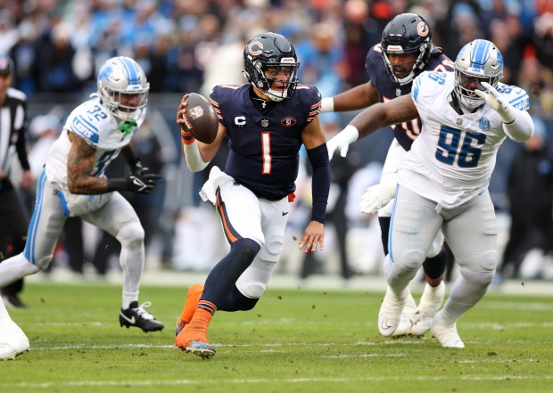 Chicago Bears quarterback Justin Fields (1) runs the ball during the first quarter of a game against the Detroit Lions on December 10, 2023 at Soldier Field in Chicago.  (Chris Sweda/Chicago Tribune)