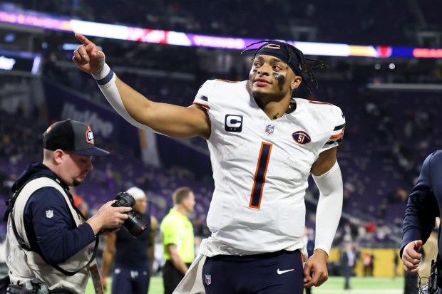 Chicago Bears quarterback Justin Fields (1) gestures to fans as he runs off the field after the Chicago Bears defeated the Minnesota Vikings 12-10 on November 27, 2023 at US Bank Stadium in Minneapolis.  (Eileen T. Meslar/Chicago Tribune)