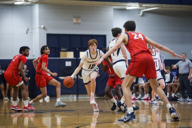 Oswego East's Noah Mason (10) dribbles on the court during the game against West Aurora on Friday, Feb. 2, 2024, in Oswego.  (Troy Stolt for Aurora Beacon News)