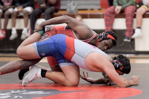 East Aurora's Arnold Walker wrestles West Aurora's Alfonso Aguilar at 215 pounds in the Class 3A East Aurora Regional semifinals on Saturday, Feb. 3, 2024, in Aurora.  (Mark Black / The Beacon-News)User Upload Title: TK