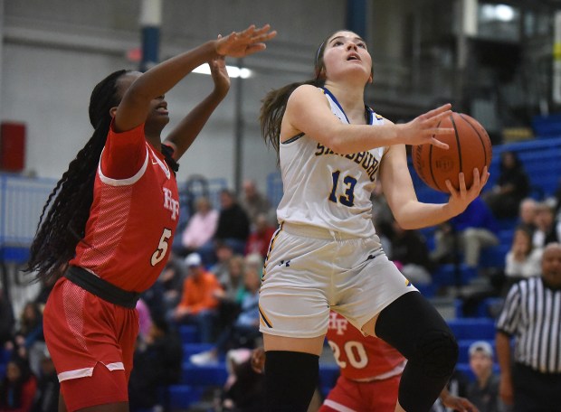 Sandburg's Juliana Paddock (13) shoots against Homewood-Flossmoor's Ihuoma Ozoh (5) during a Southwest Suburban Conference game on Tuesday, January 30, 2024 in Orland Park, IL.  (Steve Johnston/Daily Southtown)