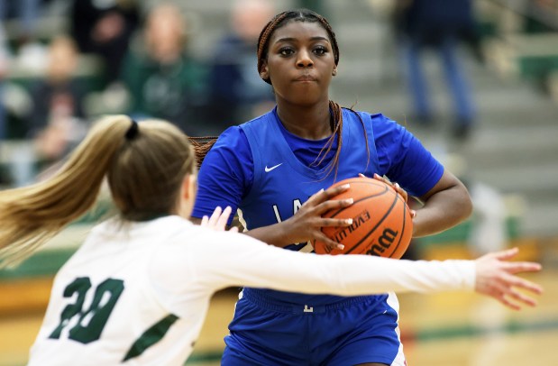 Larkin's Sanaii McPherson (22) prepares to pass while defending against Bartlett's Lilia Crawford (20) during an Upstate Eight Conference matchup on Monday, Feb. 5, 2024, in Bartlett.  Larkin won 51-50H.  Rick Bamman / For Beacon News