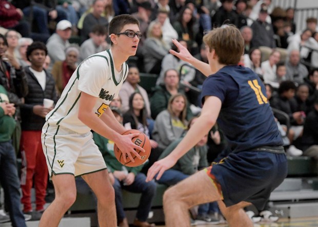 Waubonsie Valley's Ryan Morton (5) looks to open against Neuqua Valley's Whitman Charboneau (11) at home in Aurora on Friday, Jan. 5, 2024.  (Mark Black / The Beacon-News)