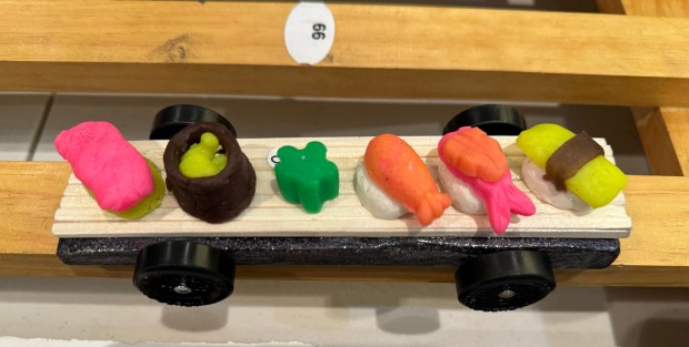 This cart with sushi on it was driven by 11-year-old Wyatt Ghantous, a Winnetka fifth-grader at Skokie School, son of Winnetka native Khalid Ghantous, Cubmaster of Cub Scout Pack 18, at the Jan. 18 Pinewood Derby. Designed for.  31, 2024 at Winnetka Presbyterian Church (1255 Willow Road) in Winnetka.  Yes, Wyatt eats sushi.  Green wasabi was worn in honor of my father's taste.