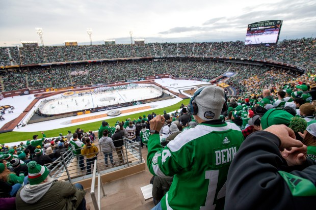 Dallas Stars fans watch during the second period of the NHL Winter Classic hockey game between the Dallas Stars and the Nashville Predators at the Cotton Bowl on Wednesday, Jan. 1, 2020, in Dallas.  The match that Dallas won 4-2.  (AP Photo/Jeffrey McWhorter)