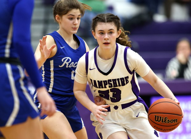 Hampshire's Ashley Herzing (33) drives into the lane past Burlington Central's Emersyn Fry (4) during a Fox Valley Conference game at Hampshire on Wednesday, Feb. 7, 2024.  Hampshire won 58-50.  Rick Bamman / For Beacon News
