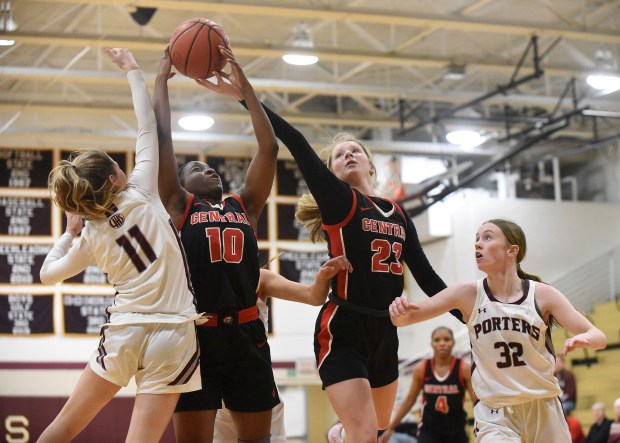 Lincoln-Way Central's Kiya Newson (10) and Brooke Baechtold (23) try to grab a rebound from Lockport's Addison Foster (11) and Lucy Hynes (32) on Monday, November 28, 2022 in Lockport, IL.  (Steve Johnston/Daily Southtown)