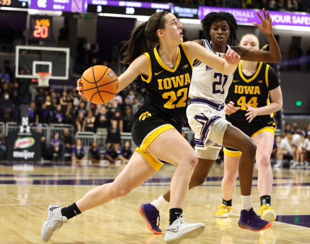 Iowa Hawkeyes guard Caitlin Clark drives to the basket while being defended by Northwestern Wildcats guard Melannie Daley during the second half at Welsh-Ryan Arena in Evanston on Jan. 31, 2024.