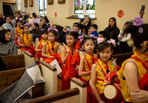 St.  Therese School artists will perform at St. Peter's Church in Chinatown on February 11, 2024.  Therese watches a lion dance perform in the aisles during mass to celebrate the Lunar New Year at the Chinese Catholic Church.  (Brian Cassella/Chicago Tribune)
