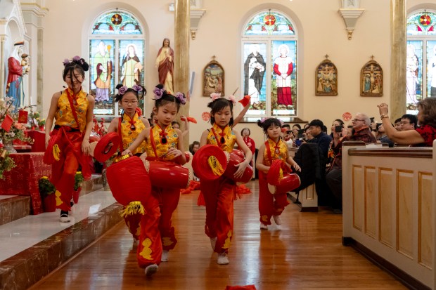 St.  Therese School children at St. Mary's Church in Chinatown on February 11, 2024.  Therese performs a drum dance to celebrate the Lunar New Year at the Chinese Catholic Church.  The Year of the Dragon began on Saturday.  (Brian Cassella/Chicago Tribune)