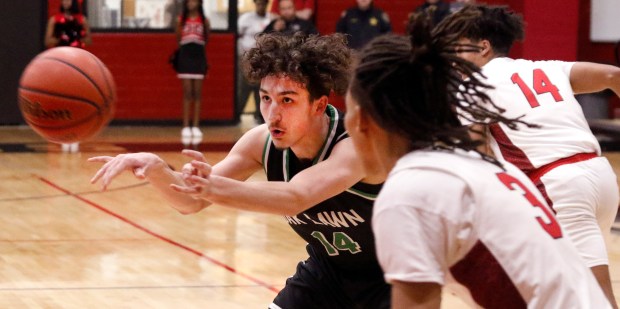 Sean Ryan (14) of Oak Lawn passed away Ayipey Salinas (3) of Eisenhower during a basketball game on Tuesday, February 13, 2024 in Blue Island.  (John Smierciak/Daily Southtown)