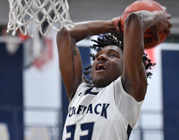 Oswego East's Jehvion Starwood dunks during a game on Tuesday, Feb. 13, 2024, in Oswego.(Jon Cunningham for The Beacon-News)