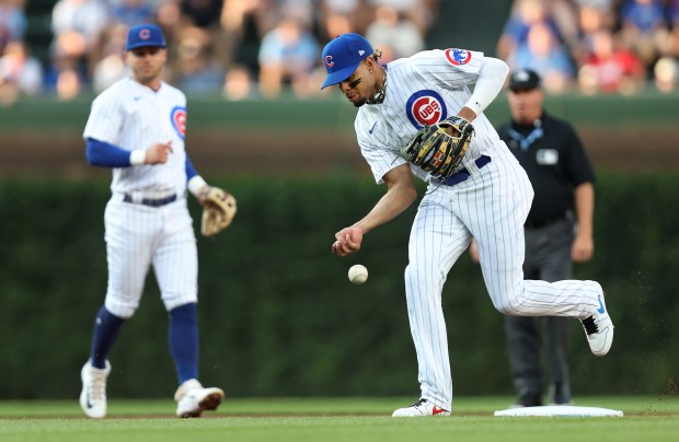 Cubs second baseman Christopher Morel (right) fails to make a play with his bare hands on an infield hit by Cardinals first baseman Paul Goldschmidt on July 21, 2023 at Wrigley Field.