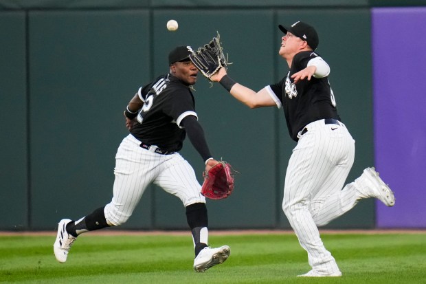 Chicago White Sox right fielder Oscar Colas, left, and right fielder Gavin Sheets, right, drive for the ball but Sheets catches it in the fourth inning of a baseball game against the Detroit Tigers on Saturday, Sept. 2, 2023, in Chicago.  .  (AP Photo/Erin Hooley)
