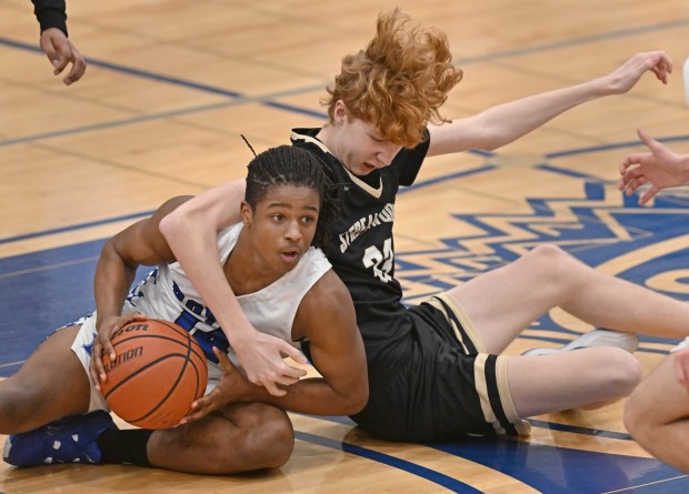 Larkin's Jonathan Wells (14) and Streamwood's Adam Hovey (33) get stuck on the ground during the 4th quarter of the IHSA Class 4A Conant Regional Quarterfinal on Monday, February 19, 2024.  Larkin won the match 77-30.  (Brian O'Mahoney of The Courier-News)