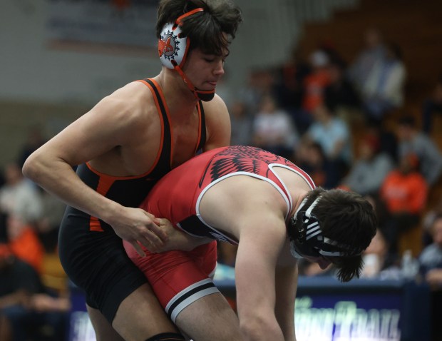 St. Charles East's Anthony Gutierrez attempts to complete Maine South's Aidan Swenson (left) in the 165-pound match during the Class 3A Addison Trail Dual Team Wrestling Regional Championships at Addison Trail High School in Addison on Tuesday, February 2024.