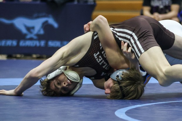 Joliet Catholic's Max Cumbee wrestles Lincoln-Way East's JT Theis in a 113-pound match in the Class 3A Downers Grove South Dual Team Regional match between Joliet Catholic and Lincoln-Way East on Tuesday, Feb. 20, 2024 in Downers Grove.  (For Troy Stolt Daily Southtown)