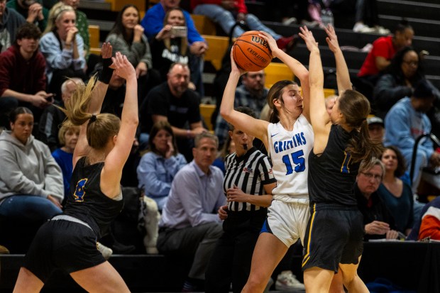 Lincoln-Way East's Lilly Dockemeyer (15) is pinned by Sandburg's Ellen Driscoll (4) and Grace Fuller (1) during the Class 4A Joliet West Regional semifinals on Tuesday, Feb. 20, 2024, in Joliet.  (Vincent D. Johnson / Southtown Daily).
