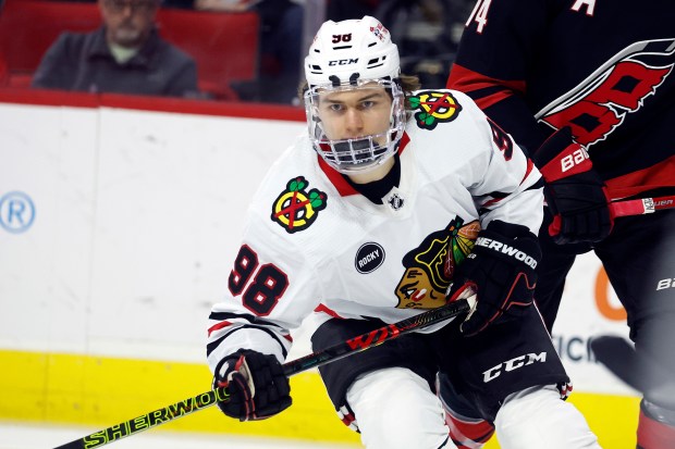 Connor Bedard (98) of the Chicago Blackhawks views the puck during the first period of an NHL hockey game against the Carolina Hurricanes on Monday, Feb. 19, 2024, in Raleigh, North Carolina.  (AP Photo/Karl B DeBlaker)