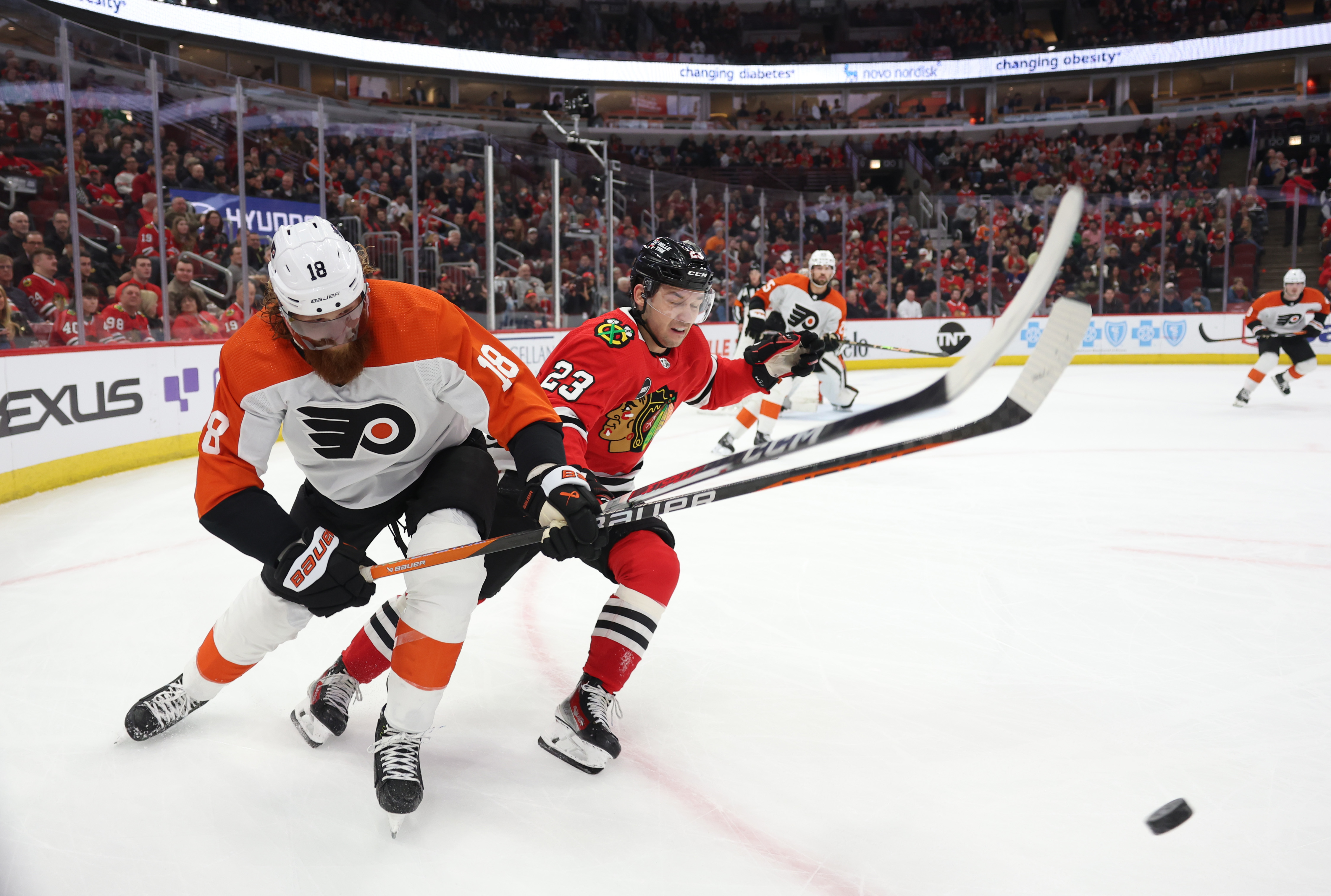 Flyers defenseman Marc Staal (18) and Blackhawks center Philipp Kurashev (23) collided while chasing the puck during the first period at the United Center on Feb. 15.  21, 2024 in Chicago.  (John J. Kim/Chicago Tribune)