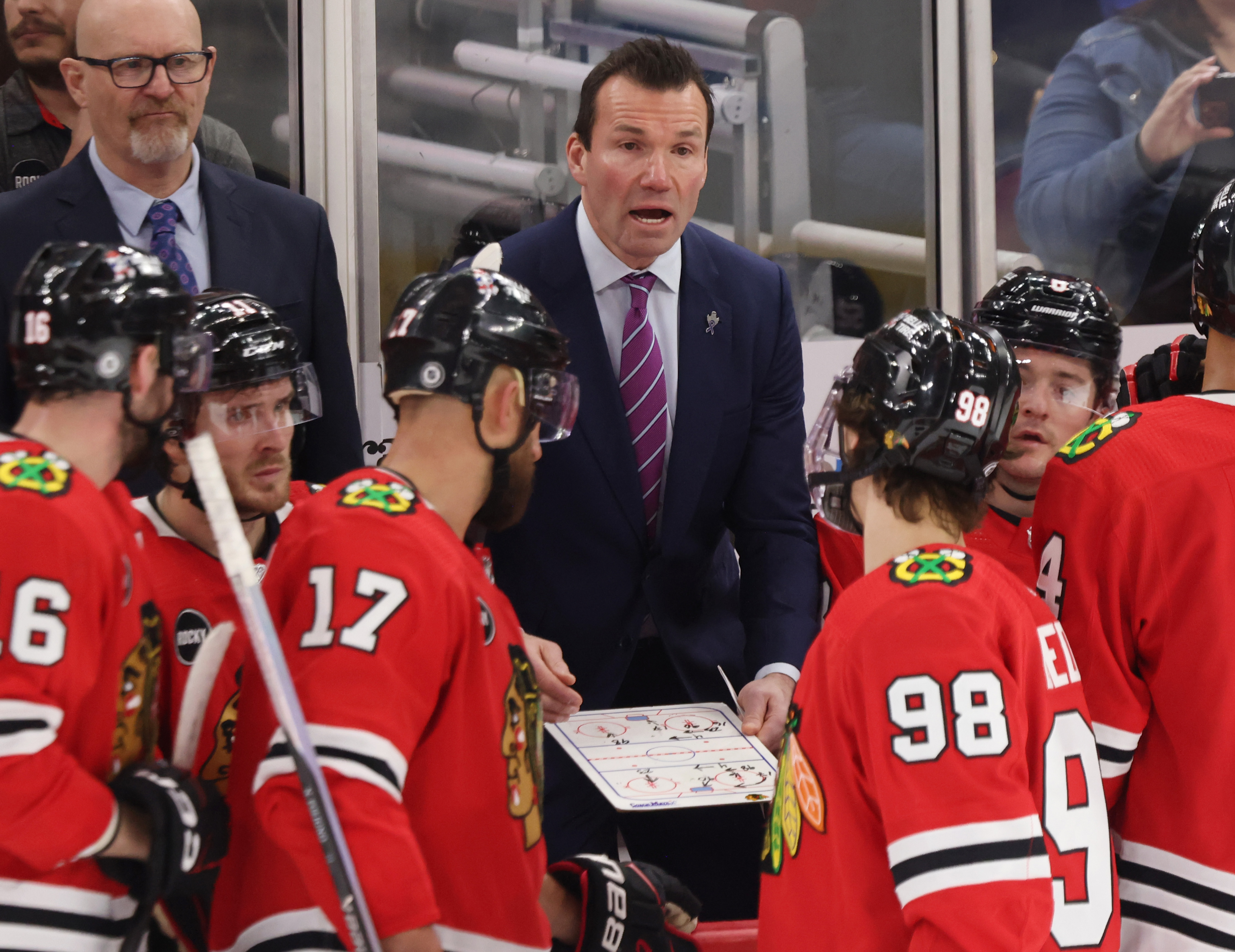 Blackhawks head coach Luke Richardson talks to center Connor Bedard (98) during a timeout in the third period against the Flyers on Feb. 21, 2024, at the United Center in Chicago.  (John J. Kim/Chicago Tribune)