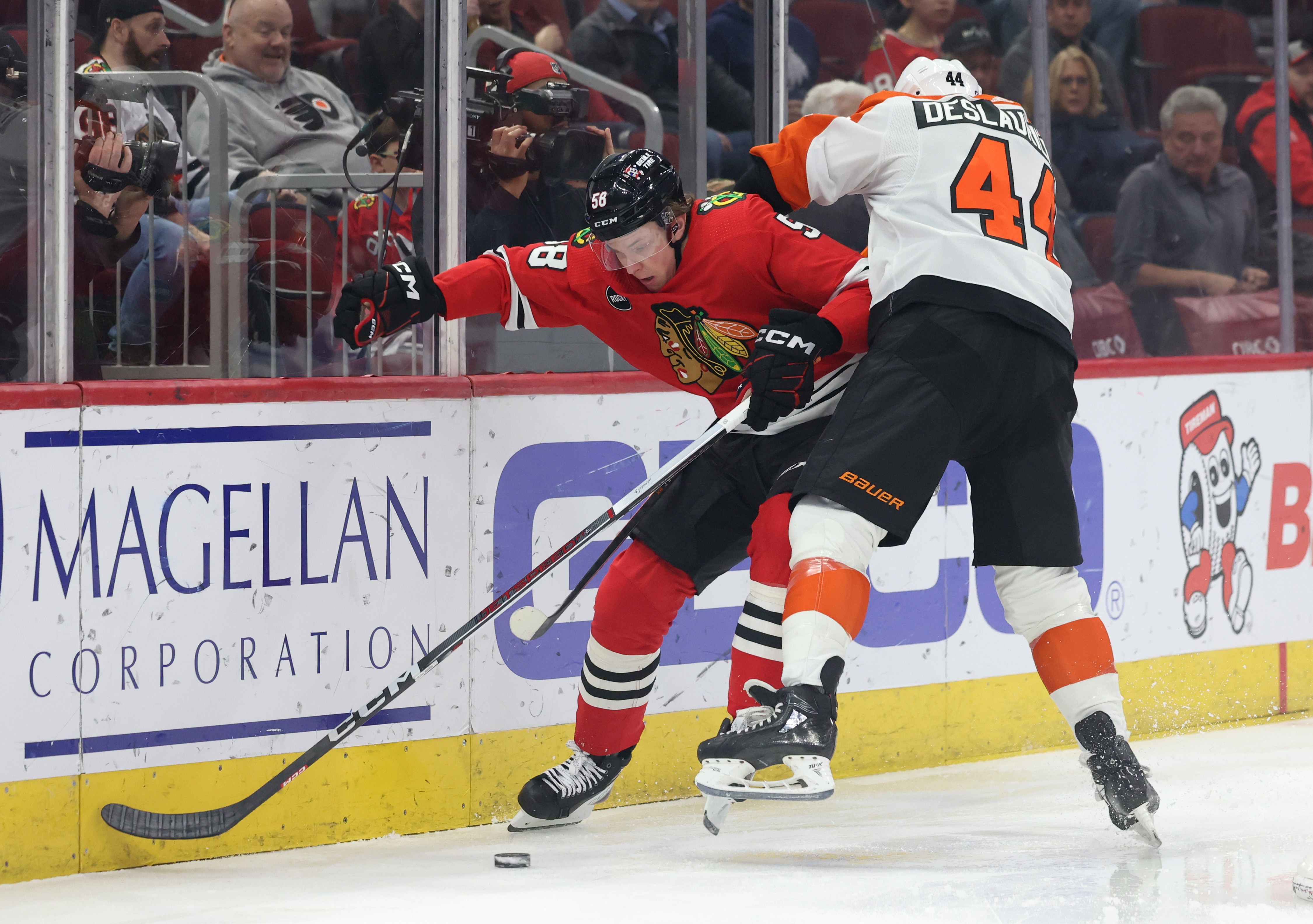 Flyers left wing Nicolas Deslauriers (44) checks on Blackhawks right wing MacKenzie Entwistle (58) during the first period at the United Center on February 21, 2024 in Chicago.  (John J. Kim/Chicago Tribune)