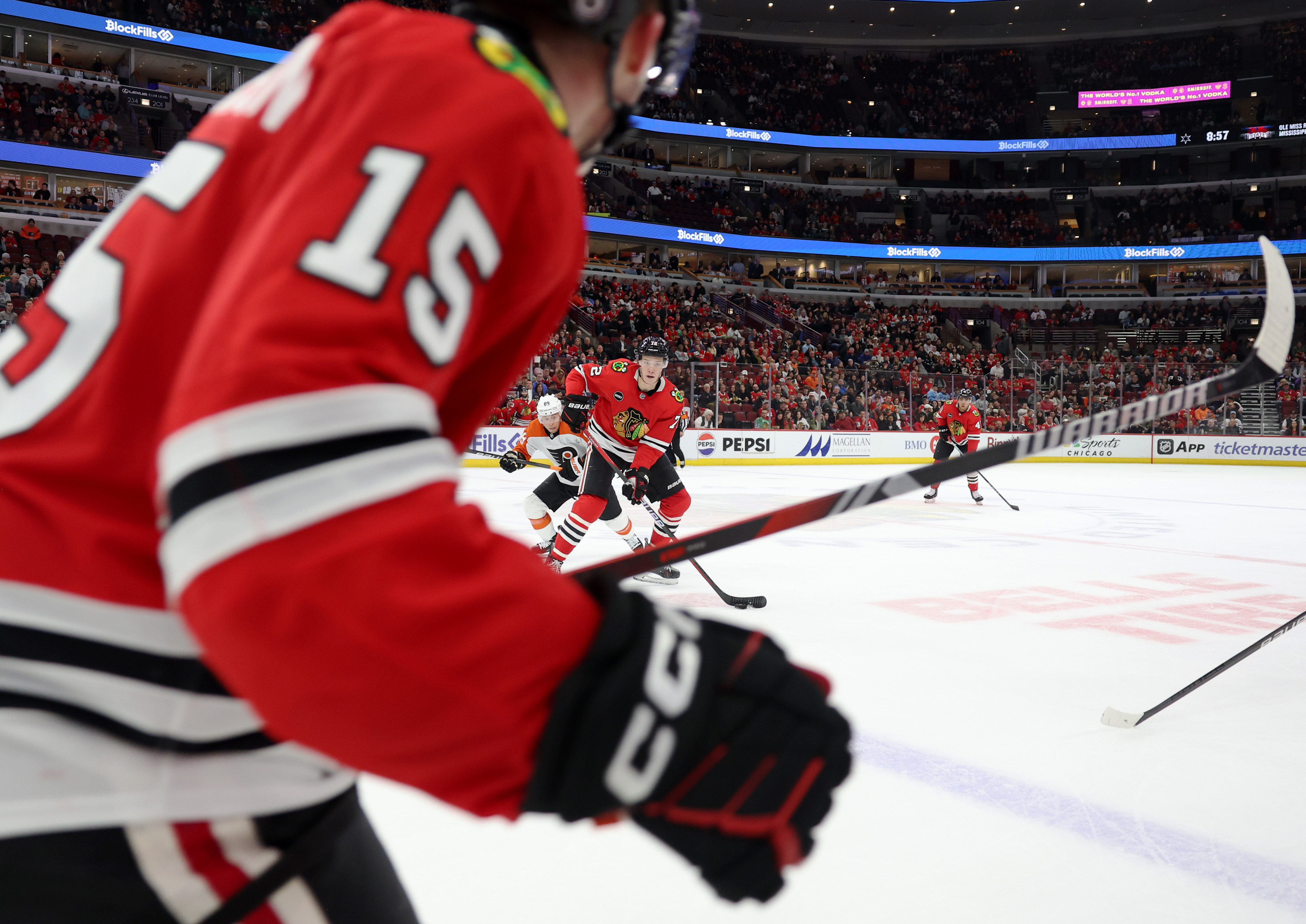 Blackhawks defenseman Alex Vlasic (72) passes the puck to right wing Joey Anderson (15) in the third period against the Flyers at the United Center on February 21, 2024 in Chicago.  (John J. Kim/Chicago Tribune)