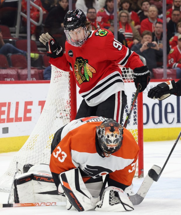 Blackhawks center Connor Bedard (98) stays behind Flyers goaltender Samuel Ersson (33) as he stops Ersson's shot on goal in the third period at the United Center in Chicago on Feb. 21, 2024.  (John J. Kim/Chicago Tribune)