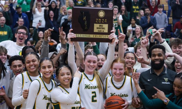 The Waubonsie Valley girls basketball team celebrates winning the Class 4A Oswego Regional championship game against Benet Academy on Thursday, Feb. 22, 2024.  (Troy Stolt for Naperville Sun)