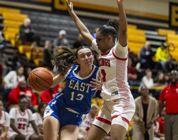 Homewood-Flossmoor's Aunyai Deere (3) tries to stop Lincoln-Way East's Maddie Yacobozzi (13) from entering the lane during the Class 4A Joliet West Regional final on Thursday, Feb. 22, 2024, in Joliet.  (Vincent D. Johnson / Southtown Daily)