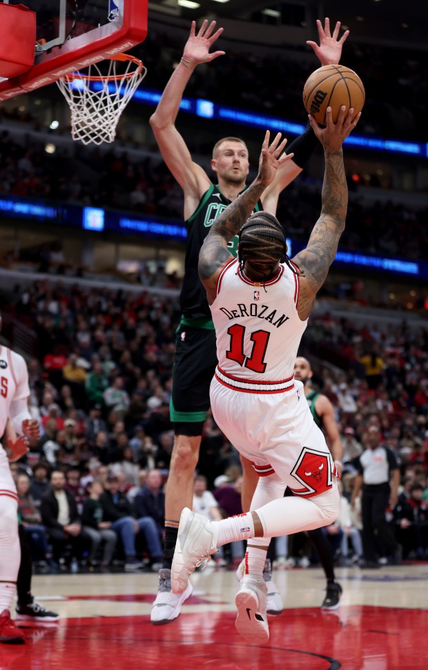 Bulls forward DeMar DeRozan (11) shoots at Celtics center Kristaps Porzingis at the United Center on February 22, 2024.