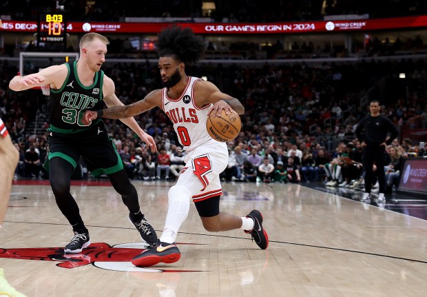 Bulls guard Coby White (R) lunges at Celtics forward Sam Hauser at the United Center on February 22, 2024.