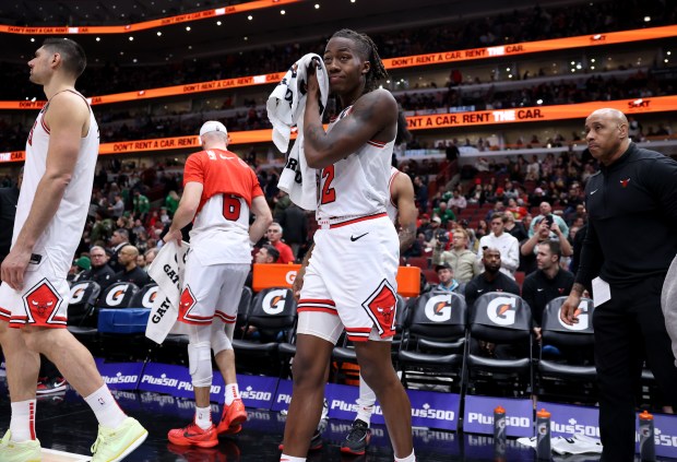 Bulls guard Ayo Dosunmu (12) wipes his face as game time expires in a loss to the Celtics at the United Center on February 22, 2024. 