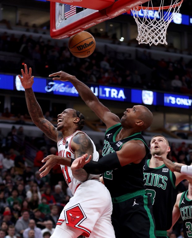 Bulls forward DeMar DeRozan's shot is blocked by Celtics center Al Horford at the United Center on February 22, 2024.